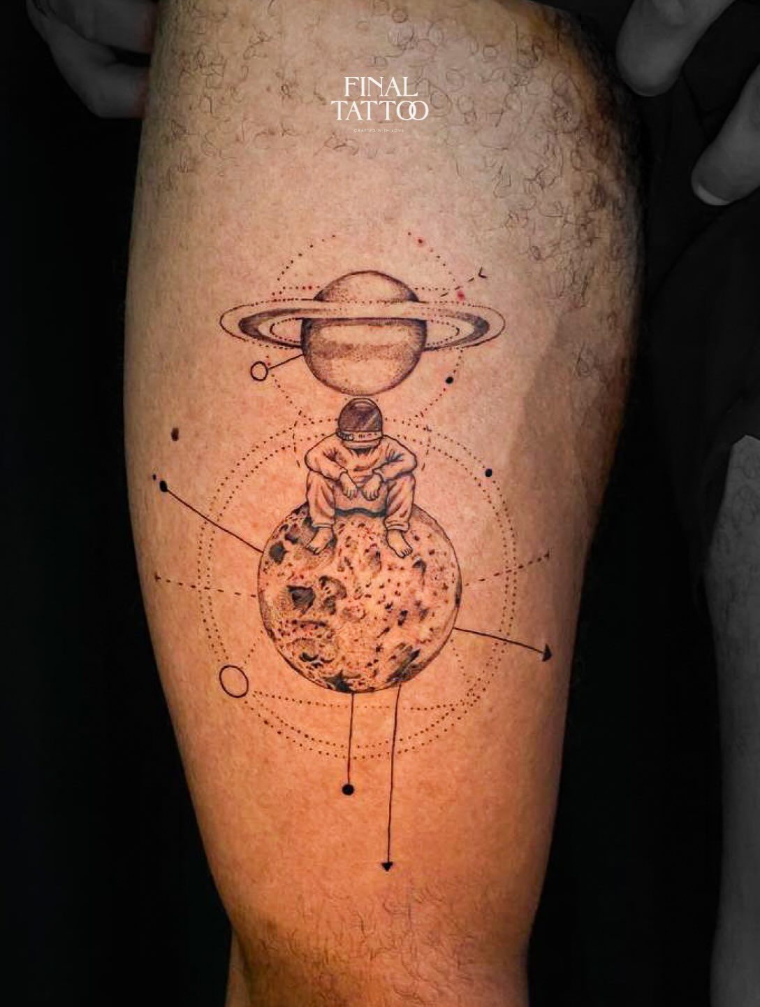 An astronaut on a moon beneath Saturn, tattooed in miniature detail